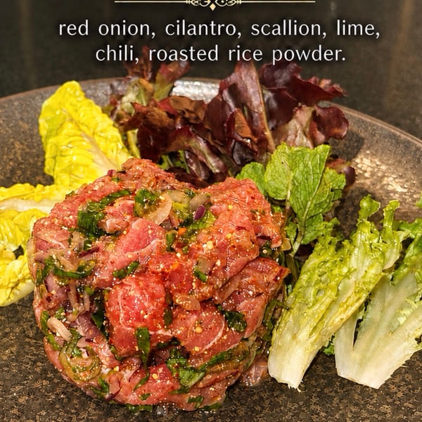 Larb Tuna, a Thai dish with red onion, cilantro, scallion, lime, chili, and roasted rice powder.