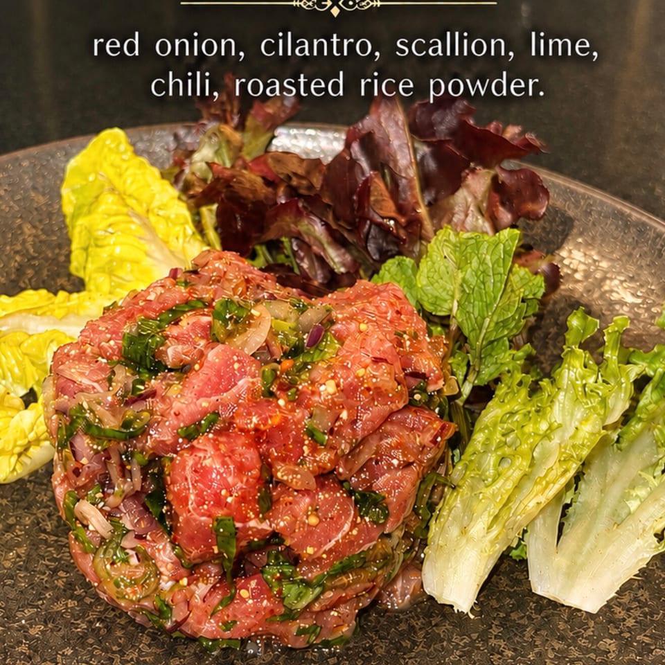 Larb Tuna, a Thai dish with red onion, cilantro, scallion, lime, chili, and roasted rice powder.